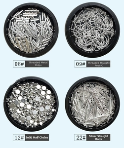 Detailed view of silver nail art metal studs including bars and beads in display cases