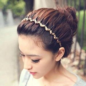 Close-up of a brown leopard print fabric headband with black teeth on a model