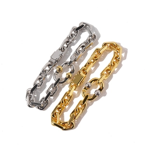 Detailed close-up of chunky gold and silver interlocking link chains with sleek metal finish
