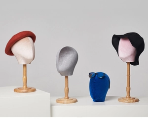 Detail of velvet mannequin heads in pink, blue, and gray for hat and eyewear display