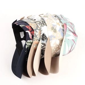 Collection of floral printed cotton baseball caps in tropical leaf patterns and various colors