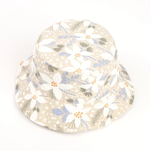 Detail of floral print bucket hat featuring white flowers and olive green leaves