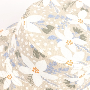 Macro shot of cotton linen bucket hat detailing leaf pattern and precise stitching