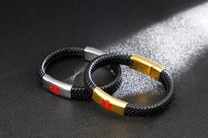 Macro detail of braided leather medical alert bracelets with red Star of Life icons