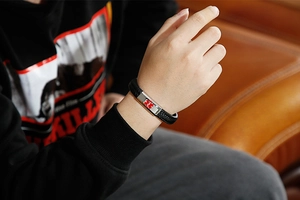 Close-up of black braided leather medical alert bracelet with stainless steel star of life
