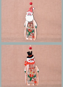 Detail of laser-cut wooden Santa and Snowman ornaments with colorful hand-painted finishes
