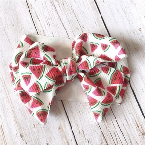Detailed close-up of a wide fabric headband featuring a 3D large watermelon print bow