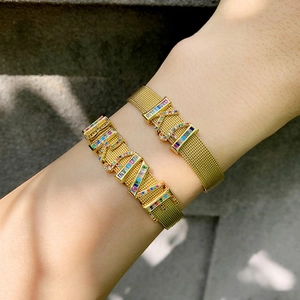 Golden mesh band bracelets featuring colorful pavé crystal LOVE letter charms