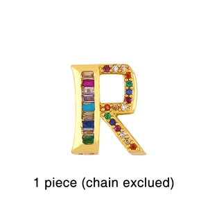 Detailed shot of golden letter R pendant set with colorful rainbow cubic zirconia