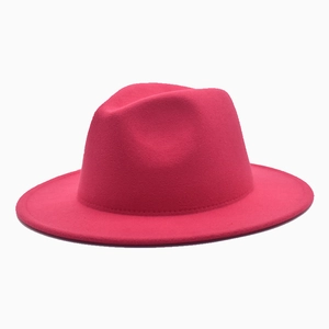 Detailed texture of rose red wool felt fedora hat with flat wide brim and classic top crown
