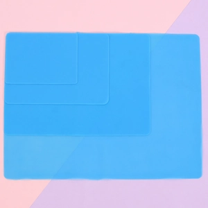 Blue silicone crafting mats in four sizes showing flexible heat-resistant material
