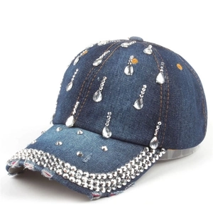 Detail of blue denim baseball cap with rhinestone water drop patterns and frayed edges