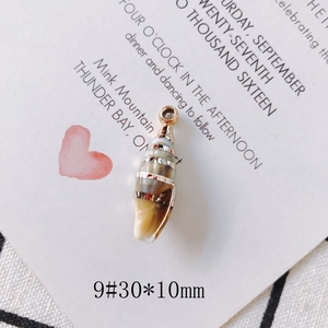Detail of 30x10mm conch shell pendant with gold plating and spiral texture for DIY jewelry