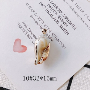 Macro view of shell pendant with gold plated edges and 32x15mm dimensions