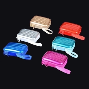 Detailed view of six colorful mini suitcase-shaped hard shell storage cases with zippers