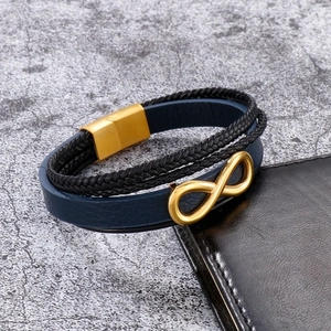 Close-up of multilayer leather bracelet with golden infinity symbol and magnetic clasp