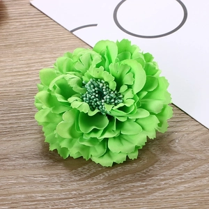 Single green fabric peony flower hair clip for hanfu on a minimalist wooden background