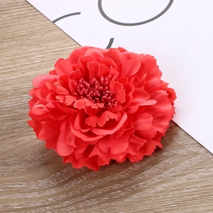 Macro detail of red fabric peony hair clip featuring layered petals and realistic stamens