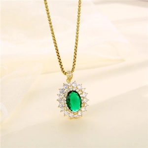 Minimalist gold necklace with oval green gemstone pendant on beige silk background