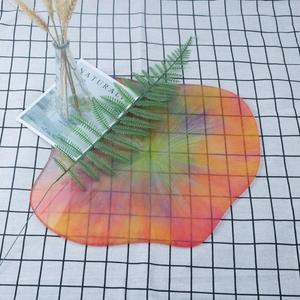 Macro shot of irregular cloud resin tray featuring vibrant orange and red sand patterns