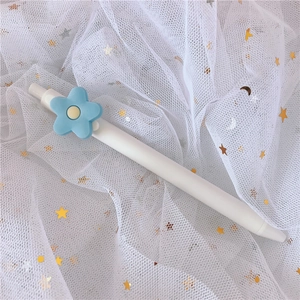 White retractable gel pen featuring a 3D blue flower detail on a starry mesh background