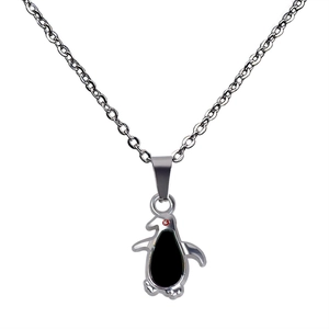 Detail of penguin mood pendant with black enamel inlay and red gem on silver chain