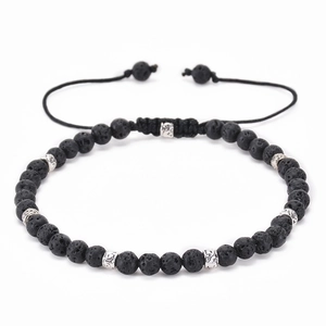 Detail of adjustable lava stone beaded bracelet with ornate silver-toned spacers