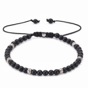 Detail of adjustable black matte stone bracelet with engraved silver metal beads