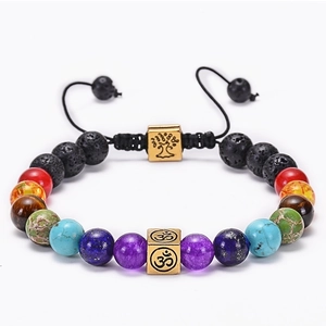 Detailed view of 8mm lava rock chakra bracelet with gold Om cube and Tree of Life
