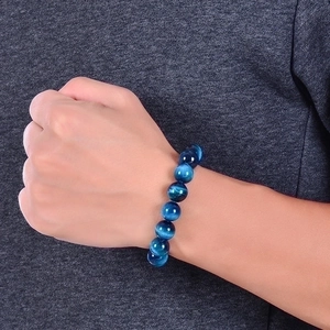 Natural sky blue tiger eye stone beaded bracelet with glossy cat eye effect on wrist
