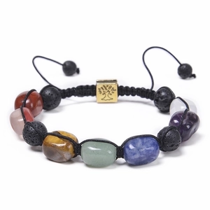 Detail of tree of life charm on adjustable natural stone bead bracelet with lava rocks