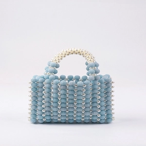 Handmade woven light blue beaded handbag with white pearl handles for elegant party wear