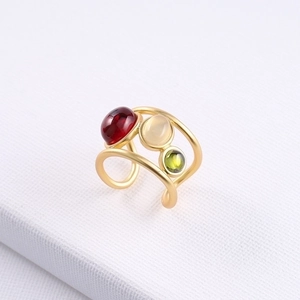 Golden multi-layer open ring featuring red, white, and green crystal gemstones