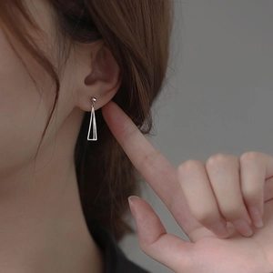 Minimalist S925 silver geometric triangle earrings worn by a model in a close-up view