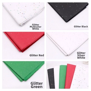 Macro view of assorted glitter tissue paper sheets in rainbow white and vibrant colors