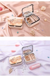 Portable jewelry box for rings and earrings featuring an interior mirror and elegant print