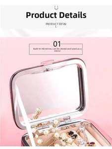 Close-up of pink jewelry box interior with built-in square mirror and jewelry storage