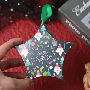 Star shaped Christmas gift box with festive Santa Claus print and green silk ribbon