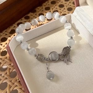 Elegant cat's eye stone butterfly charm bracelet in grey moonlight tones inside a gift box