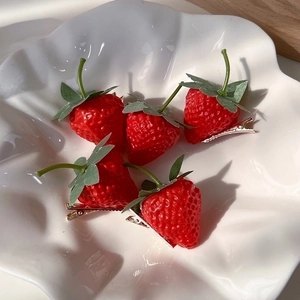 Set of five realistic 3D strawberry hair clips in a white decorative bowl for women