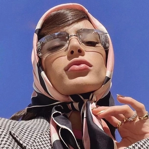 Chic rimless diamond square sunglasses paired with a pink striped scarf and coat