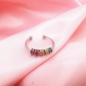 Adjustable stainless steel spinner ring with colorful enamel beads on pink satin