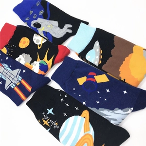Flat lay of cotton crew socks featuring galaxy astronaut and space themed patterns