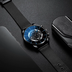 Detail macro shot of black Geneva men's watch with steel mesh strap and multi-dial face