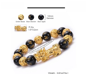 Detailed view of 12mm black agate beads and golden Pi Xiu charm on a handmade bracelet