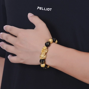 Natural black agate bracelet with gold PiXiu and Six-Syllable Mantra beads on model wrist