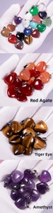 Detailed view of various natural heart-shaped stone pendants with silver metal clasps