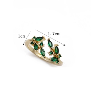 Detail shot of gold copper ring with green marquise zircon leaves and dimension marks