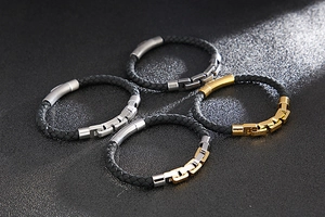 Macro detail of men's braided leather bracelets with stainless steel magnetic clasps