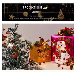 Detail of Christmas snowman doll with pine cones, red berries and warm LED wire lights